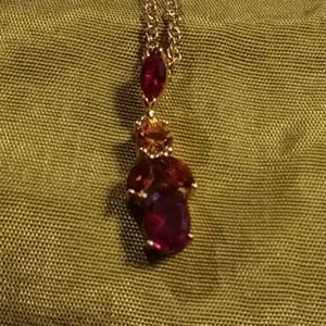 Multi colored gems in gold chain is gold accented